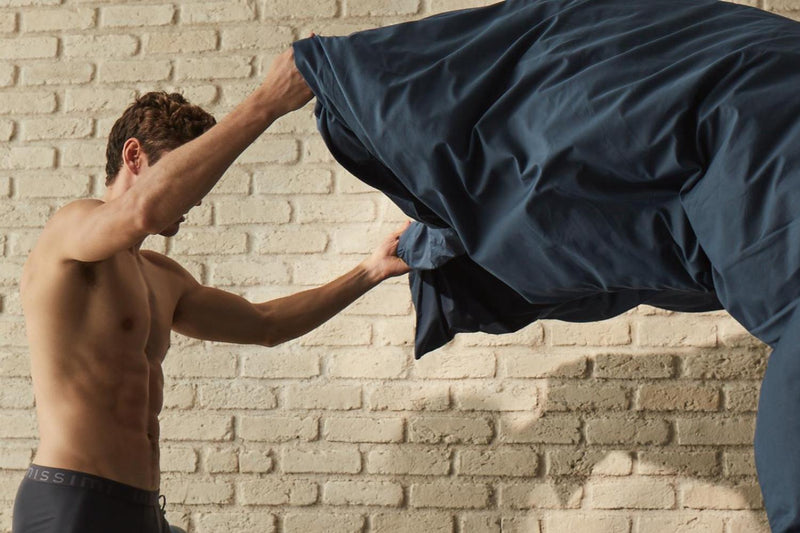 man changing bedding