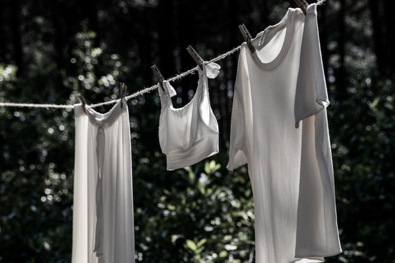 bamboo loungewear, white pyjamas hanging outside on washing line to dry in the summer sun's heat